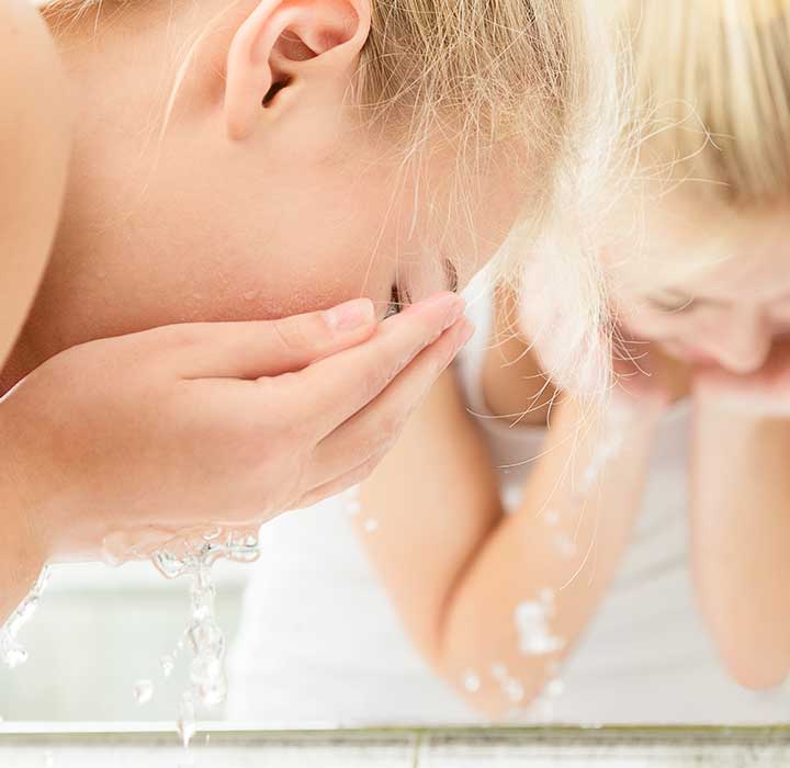 woman washing her face