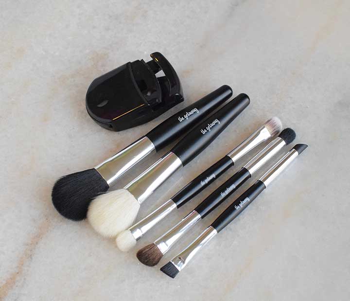 The included makeup brushes in the getaway clutch